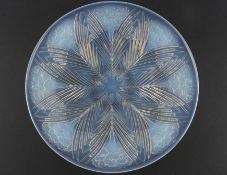 A 1930s Lalique `Oeillets` pattern moulded opalescent glass charger decorated with leaves