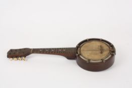 An early 20th century small banjo, unnamed. with mother of pearl roundel inset neck, the reverse