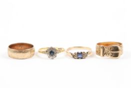A group of four assorted gold rings comprising: a 9ct gold wedding band, a 9ct gold buckle ring,