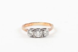 A yellow gold and three stone diamond ring set with central stone of 0.38cts flanked either side