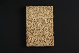 A large 19th century Chinese Canton carved ivory card case finely carved all over with figures