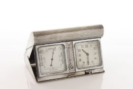An Asprey engine turned silver travelling clock barometer hallmarked Birmingham 1938, of hinged fold