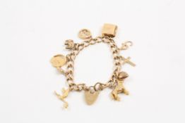 A 9ct yellow gold charm bracelet stamped .375 and set with 10 assorted charms, with heart shaped