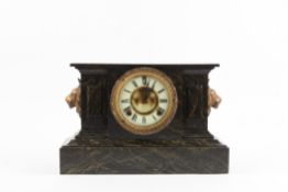 A Victorian simulated marble cast iron mantle clock crested with a spelter sphinx, the circular face