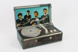 A rare 1964 Beatles record player the hinged blue case player with four speeds, with print to the