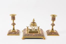 A Victorian copper and brass desk set comprising an inkwell on a square brass base with pen rests,