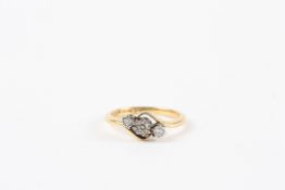 An 18ct yellow gold and diamond triple crossover ring set with central diamond of approximately