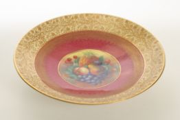 A large Royal Worcester style hand painted circular dish decorated with a central panel of fruit,