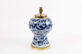 A 19th century Chinese blue and white table lamp with bulbous body decorated with scrolls and