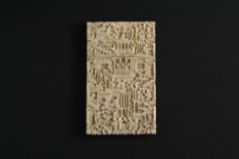 A small 19th century Chinese Canton carved ivory card case finely carved all over with figures