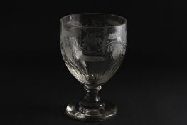 A large 19th century engraved glass goblet the body decorated with a continuous band of wheel-cut