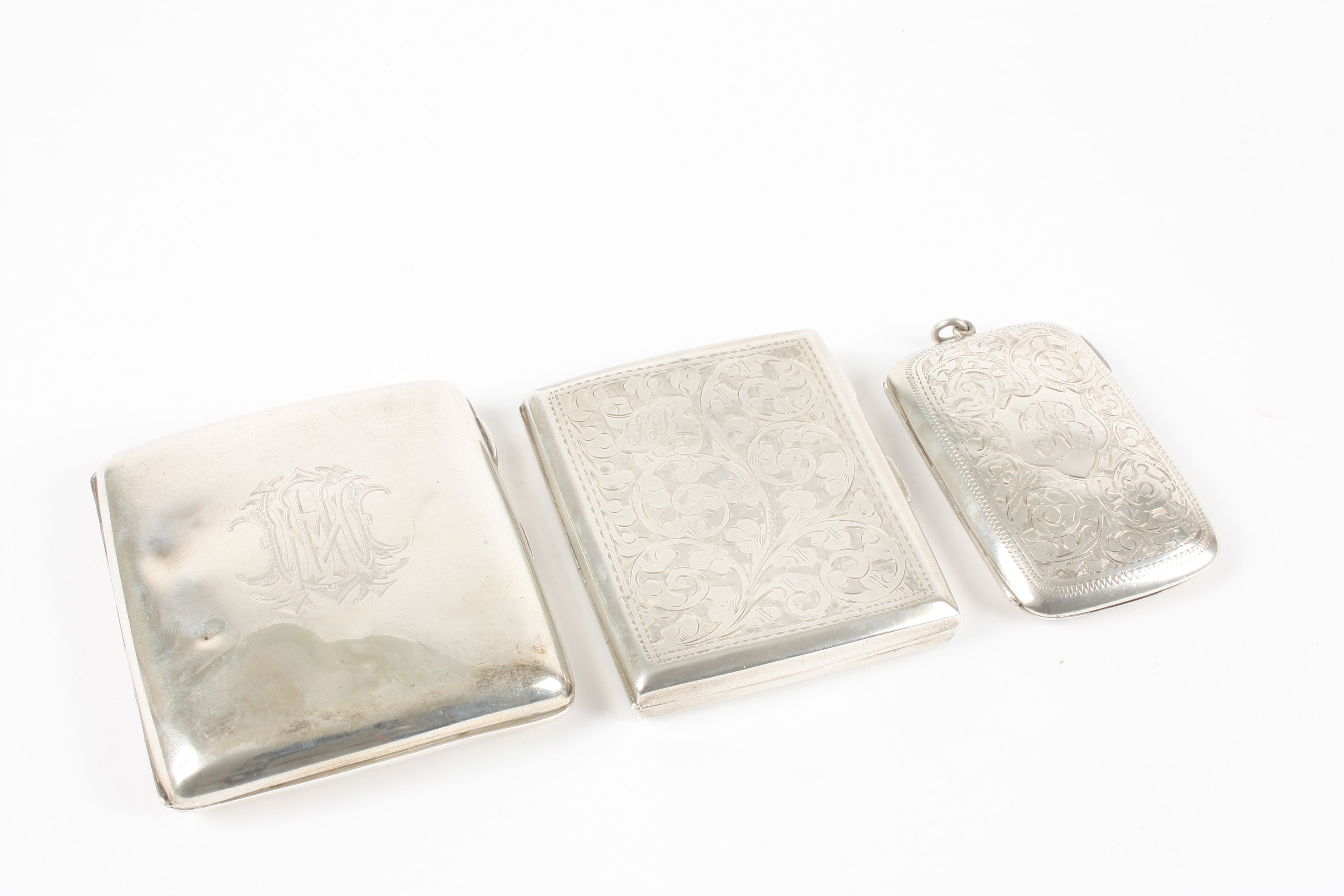 Three silver cigarette cases all hallmarked Birmingham 1898, 1909, and 1926, of various sizes,