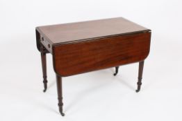 A Victorian mahogany Pembroke table?the plain top with moulded rim and a pair of hinged folding