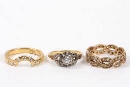 Three gold and diamond rings comprising: an 18ct gold and diamond flower head ring; an 18ct gold