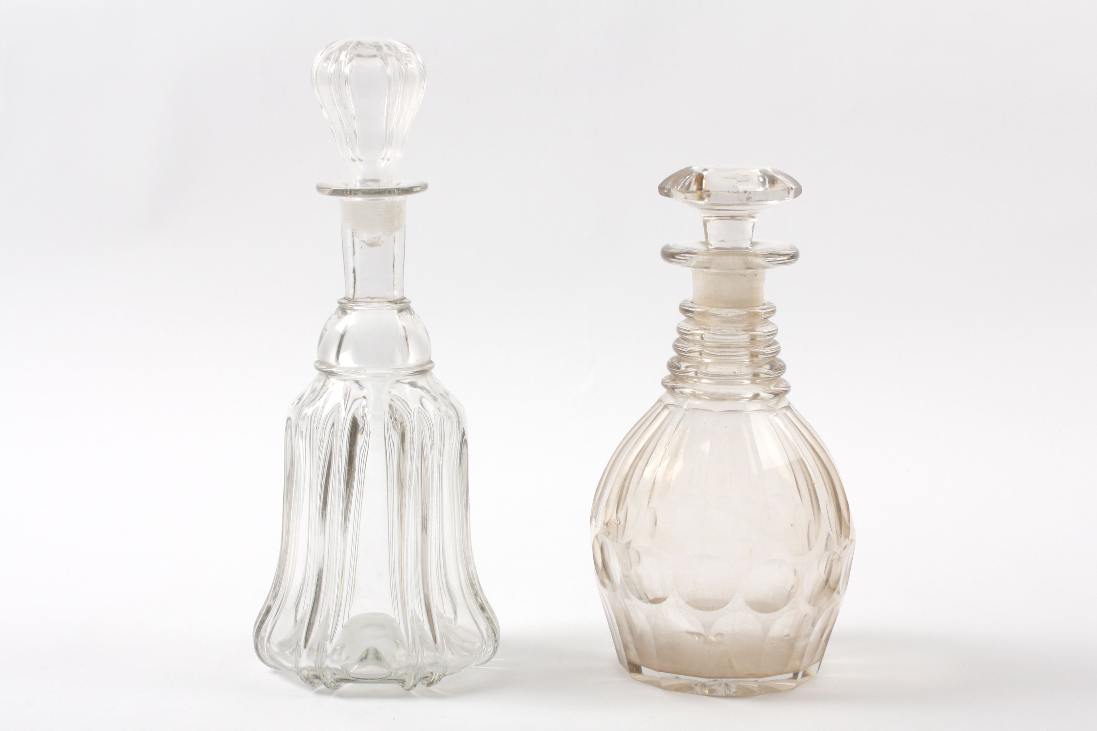 Two Victorian glass decanters One of bell shaped form, the other with facet cut sides and star cut