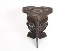 An early 20th century Anglo-Indian Kashmir carved hardwood table with triangular petal shaped top,