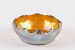 Louis Comfort Tiffany A Favrile small glass dish of golden iridescence with blue and purple