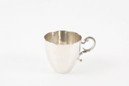 A Victorian white metal cup, with fluted rim and tapered body, with cast scrolled and beaded handle.