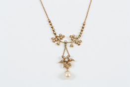 An Edwardian 15ct gold, seed pearl and pearl necklace stamped 15ct, the frame mounted with seed