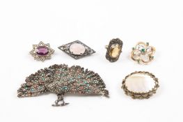 A small collection of costume jewellery comprising a silver and marcasite peacock brooch, a