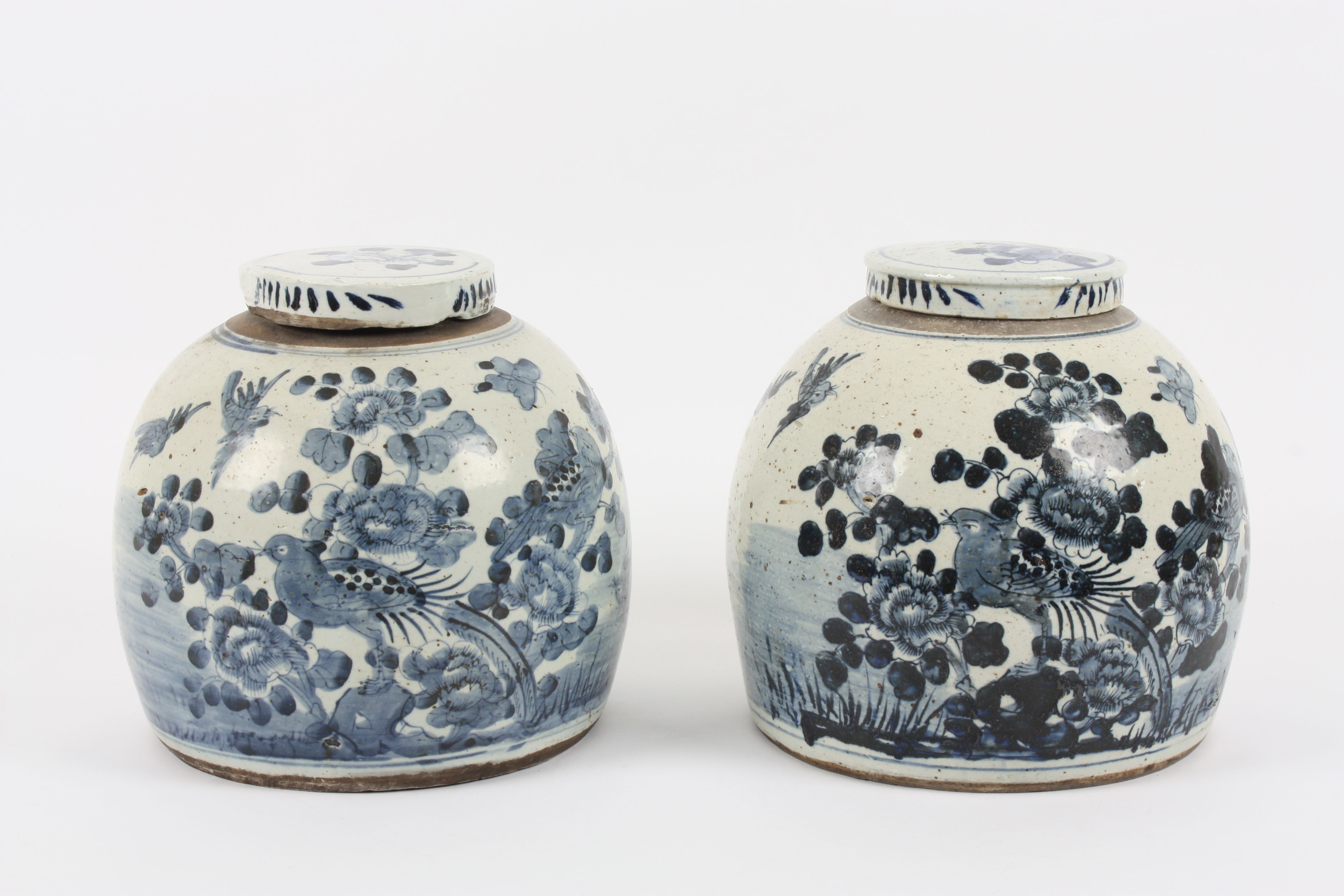 A large pair of Chinese earthenware ginger jars and covers the bodies of bulbous form, decorated