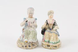 Two early 20th century Continental porcelain seated ladies resplendent in 18th century costume,