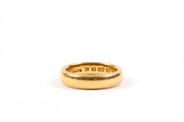A George V 22ct gold wedding band hallmarked London 1926. 10 grams. Some wear.