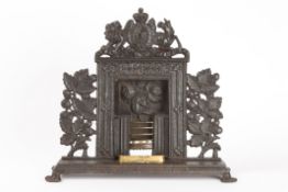 A miniature salesman`s sample cast iron fireplace late 19th century complete with grate, heavily
