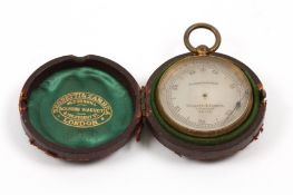 A Victorian Negretti & Zambra pocket compensated barometer in a brass case with silvered dial,