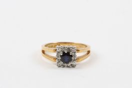 A sapphire and diamond Art Deco style ring with central circular sapphire surrounded by 12