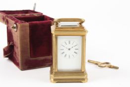 A French Victorian brass eight day miniature carriage clock with white enamel dial and black Roman