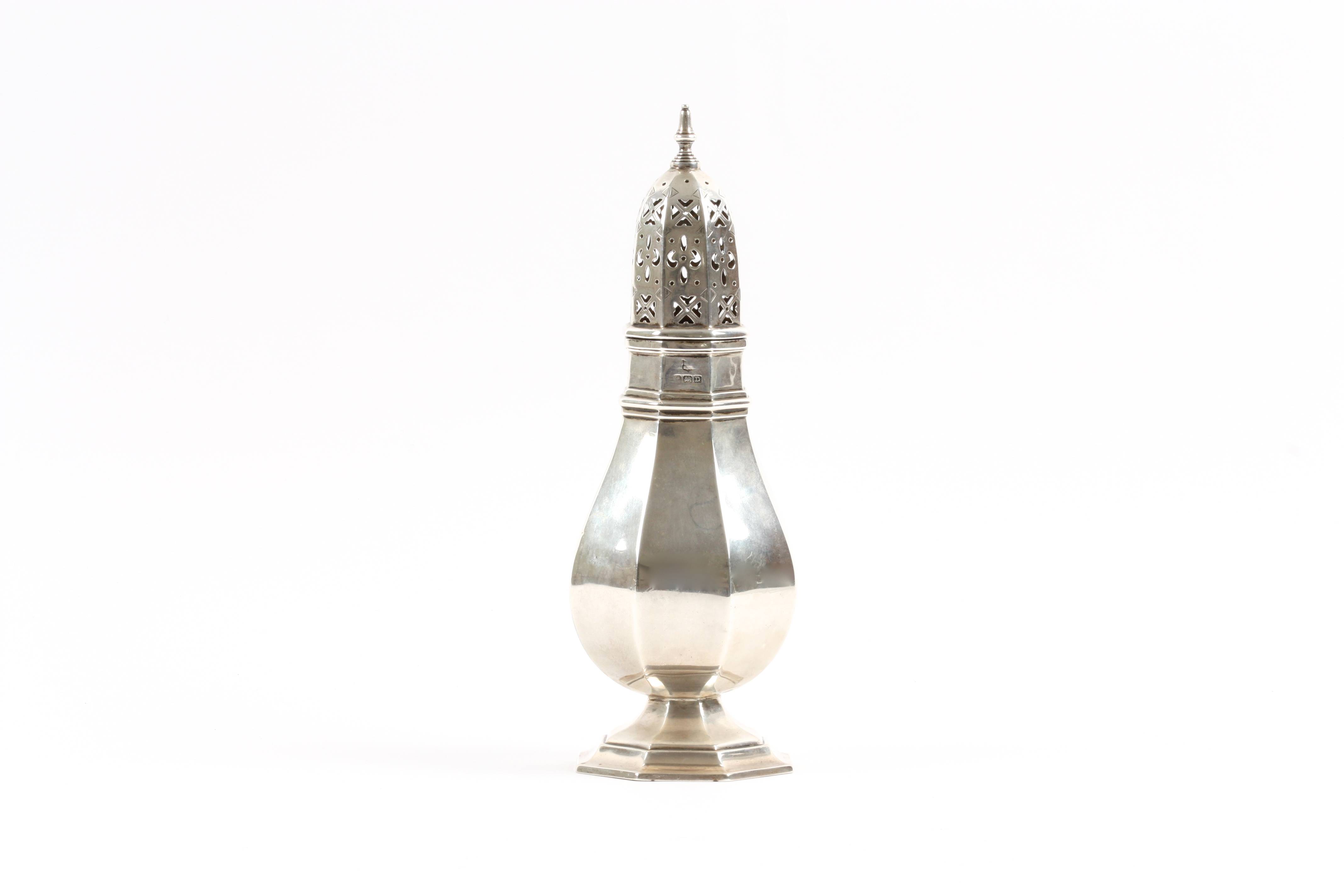 A George V silver octagonal sugar sifter hallmarked Birmingham 1928, of baluster form. 23cm high,