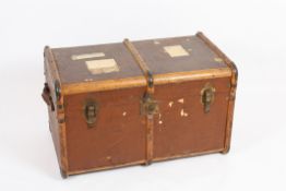 A vintage travelling trunk the canvas covered case with wooden struts and brass lock and hinges,