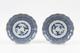 A pair of Chinese late Qing dynasty circular plates with shaped rims, painted with naive landscape