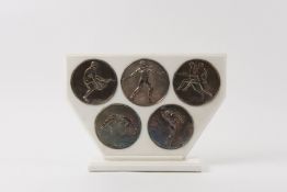 Antigone Filippaki (Greek) An unusual set of five silver `Olympic` relief plaques, depicting