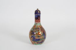 An unusual late 19th/early 20th century overpainted Chinese bottle vase and cover the body overglaze