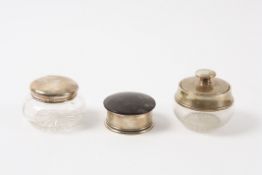 Three assorted silver dressing table jars hallmarked London 1928, London 1915 and London 1919.