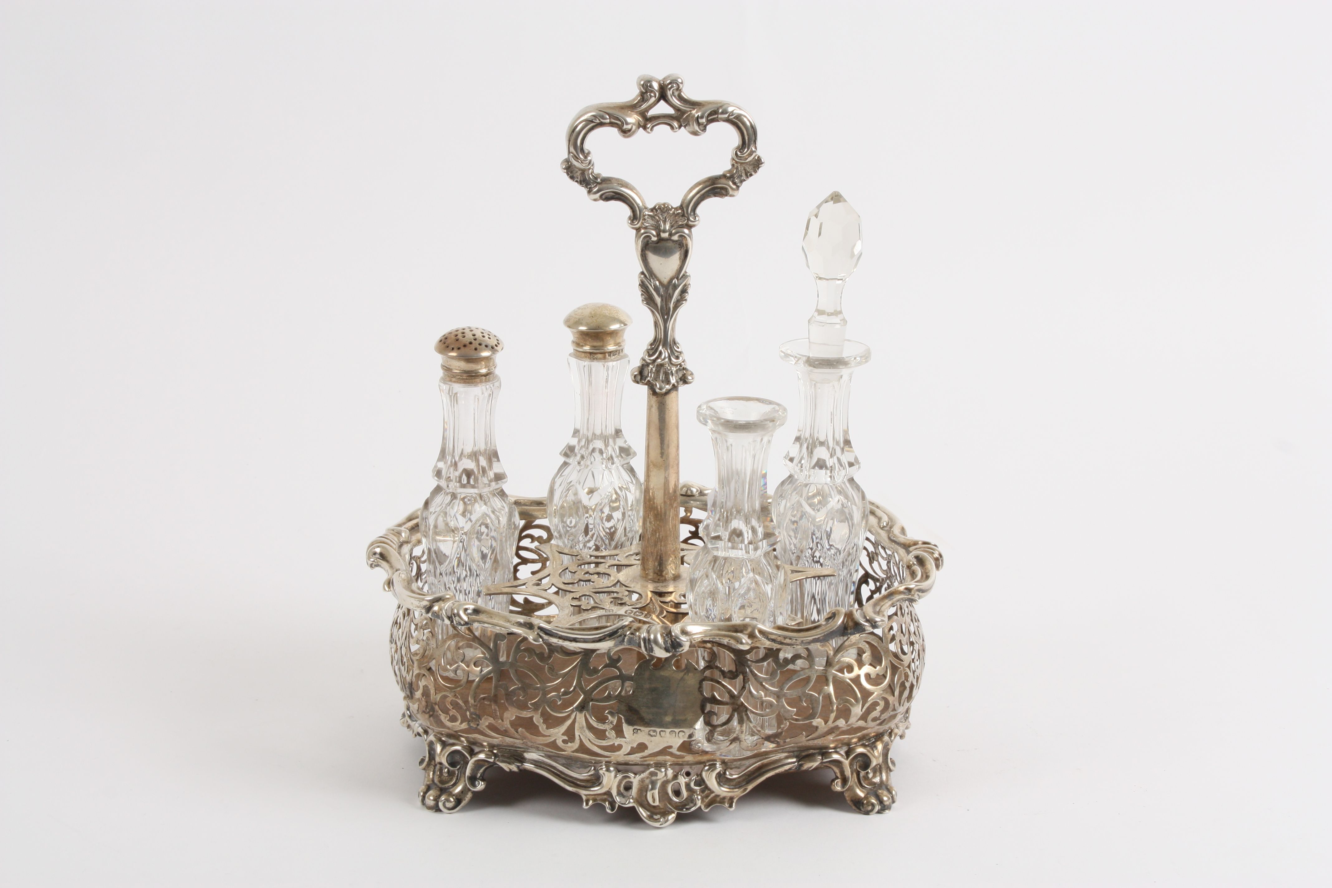 An early Victorian silver cruet stand with partial contents hallmarked London 1844, the body of
