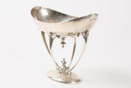 An Edwardian Art Nouveau hammered silver dish hallmarked London 1904, the oval dished top, held