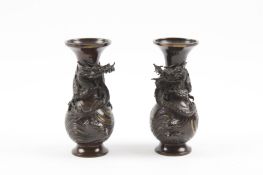 A pair of Japanese Meiji period bronze vases each mounted with an applied dragon wound round the