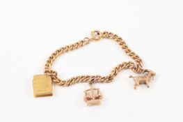 A 9ct yellow gold charm bracelet set with three charms, each stamped 9ct. 17.8 grams. Good