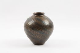 A mid 20th century Japanese bronze vase the body with spiral hammered decoration with interspersed