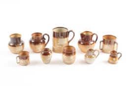 A collection of ten Doulton Lambeth stoneware saltglaze miniature and larger items comprising: a