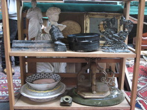 TWO SHELVES OF SUNDRIES INCLUDING FRAMED WALL PLAQUES, CERAMICS, WALL MIRROR, WALL SCONCES, ETC.