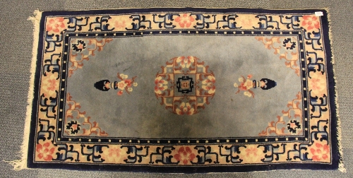 A Sino Tibetan hand made woollen rug 139cm x 76cm