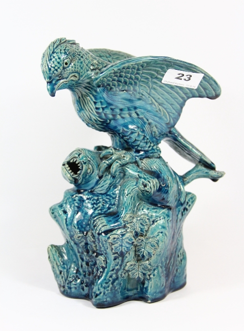 A 19th century Chinese blue glazed stoneware figure of a bird attacking an animal H 27cm