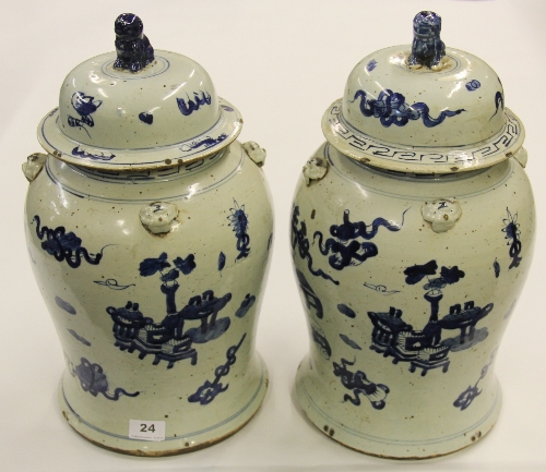 A pair of 19th century Chinese hand painted provincial porcelain jars and lids decorated with