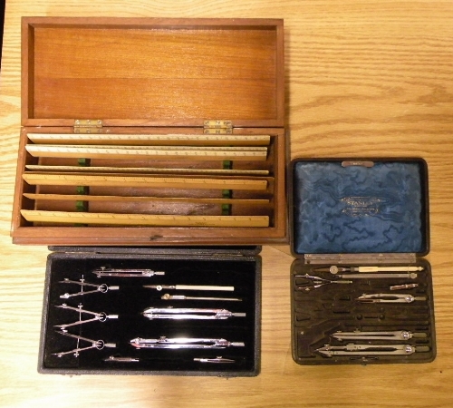 A mahogany cased set of rulers and 2 drawing sets