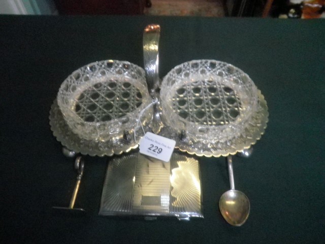 A pair of cut glass dishes on a bright cut decorated silver plated stand, together with a silver