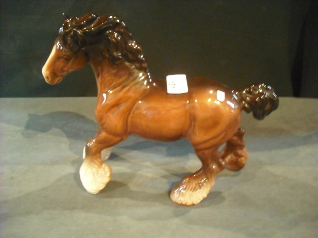 A Beswick model of a heavy horse, brown gloss glazed.